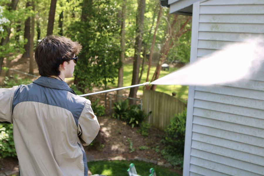Soft wash house washing service being applied to home siding in Raleigh NC by Pressure Boys NC
